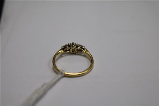 An 18ct gold and three stone diamond ring, set with pear and marquise cut stones, size K.